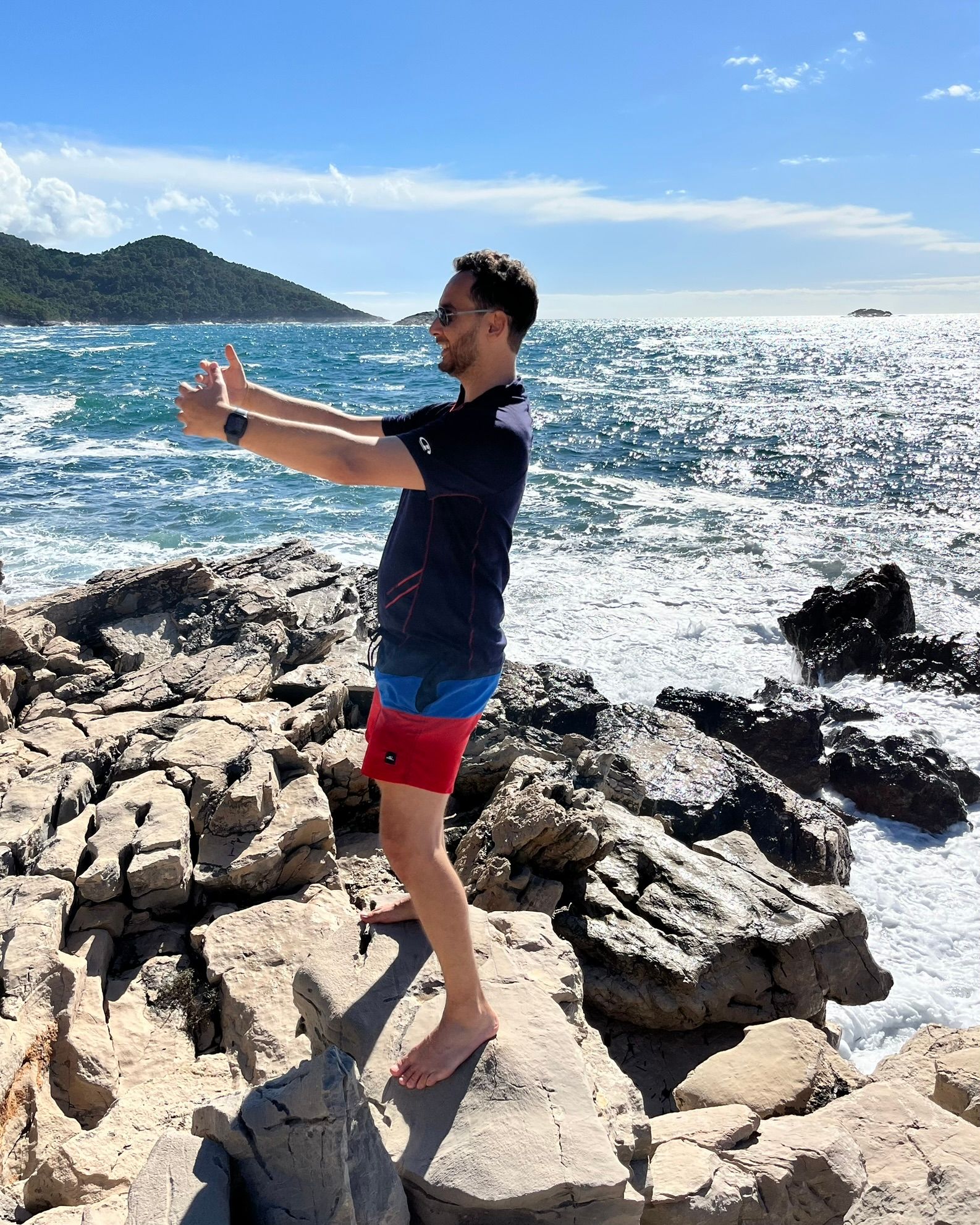 Silviu Necoara en posture, ancré sur les rochers face à la mer